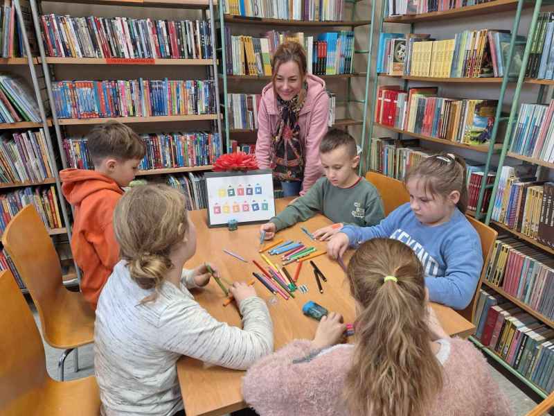 zdjęcie dzieci i nauczycielki przy stoliku