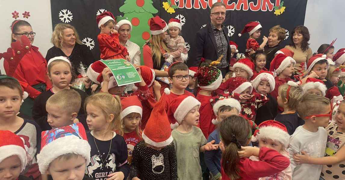 zdjęcie burmistrza, pracowników przedszkola i biblioteki w otoczeniu dzieci