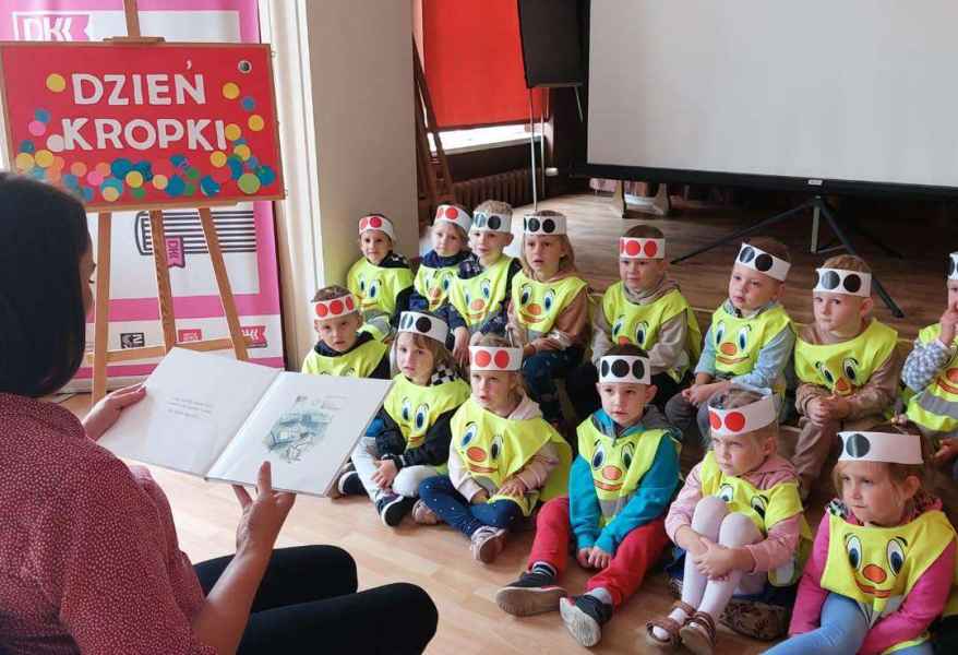 zdjęcie bibliotekarki czytającej dzieciom bajkę