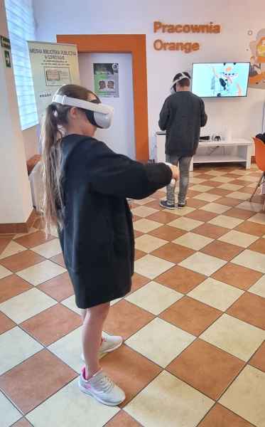 zdjęcie dziewczynki i chłopca z goglami VR podczas gry
