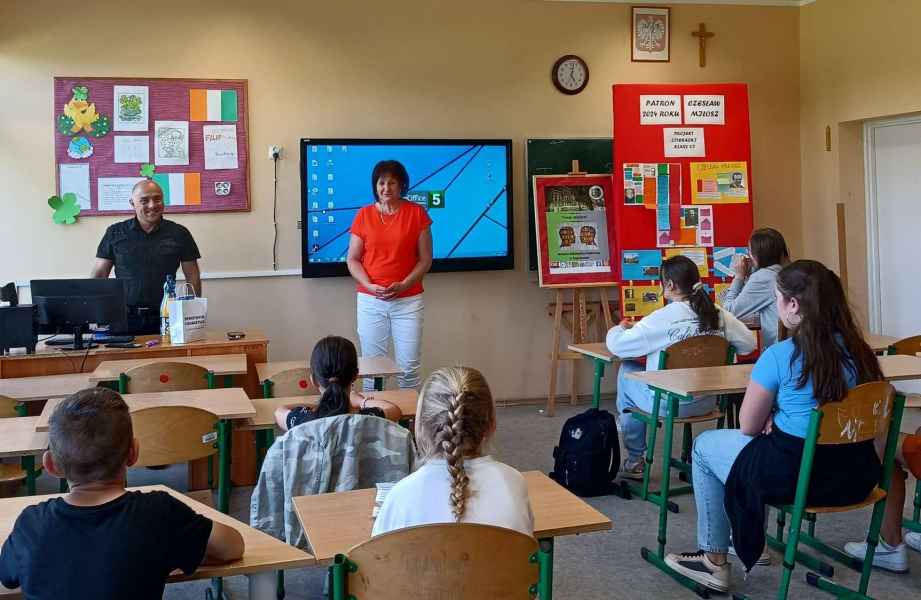 zdjęcie nauczycielki i regionalisty mówiących do dzieci w klasie