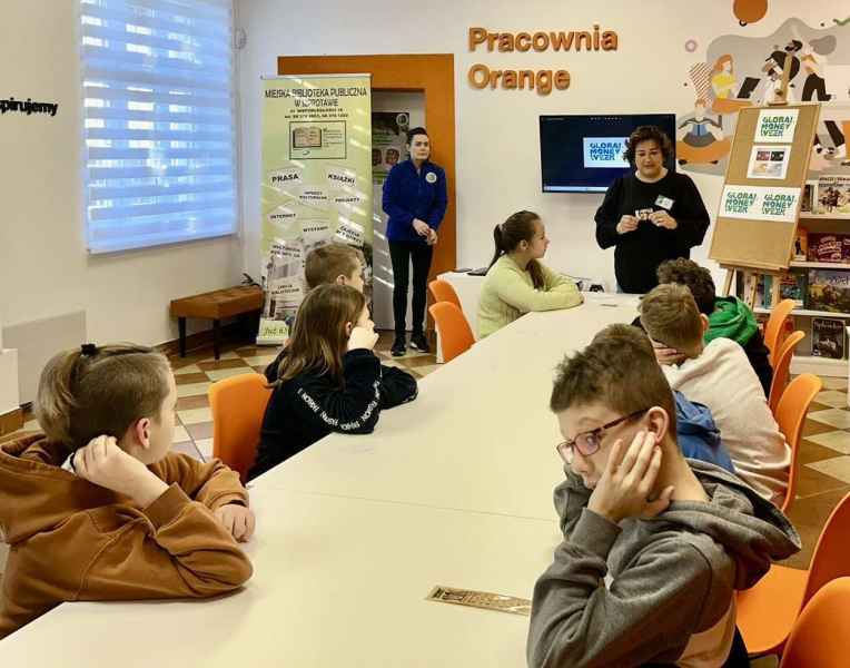 zdjęcie bibliotekarki opowiadającej dzieciom o pieniądzach